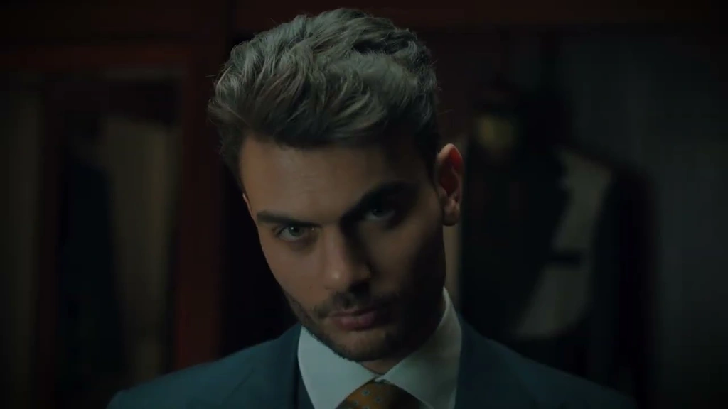 A close portrait of a man in a dark suit and tie.