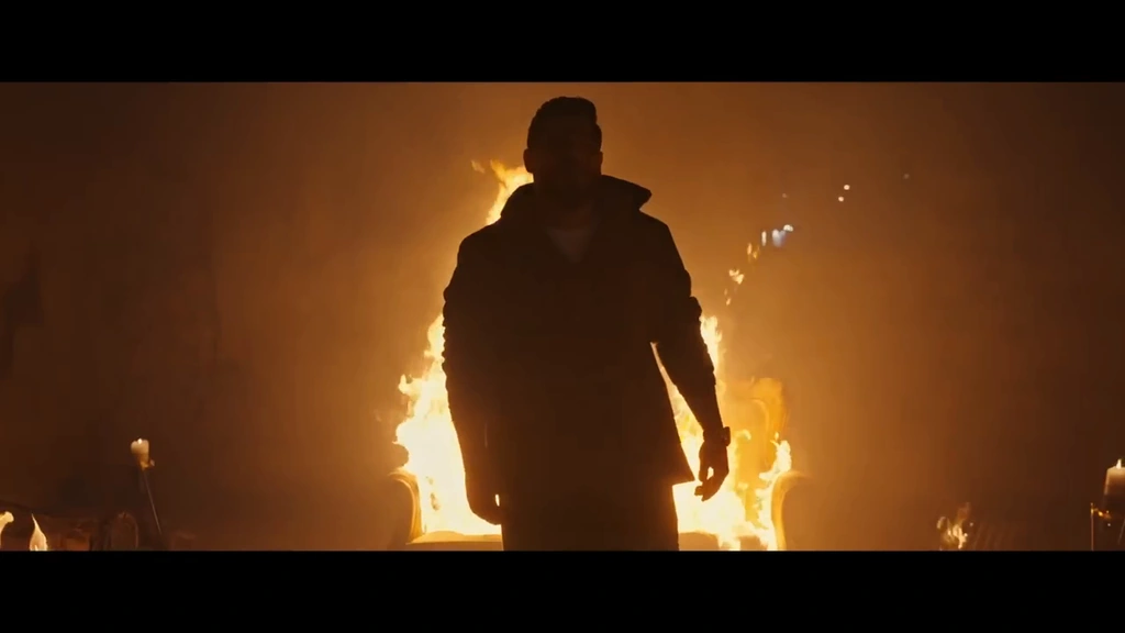 A silhouetted figure is outlined by orange firelight.