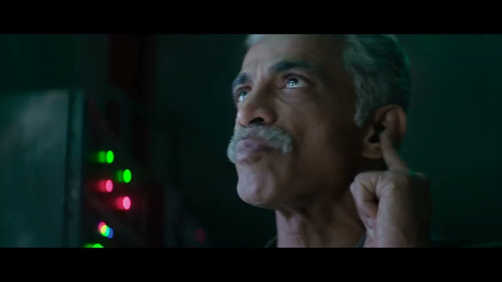SPY — Cool-toned close-up beside colored monitor lights.