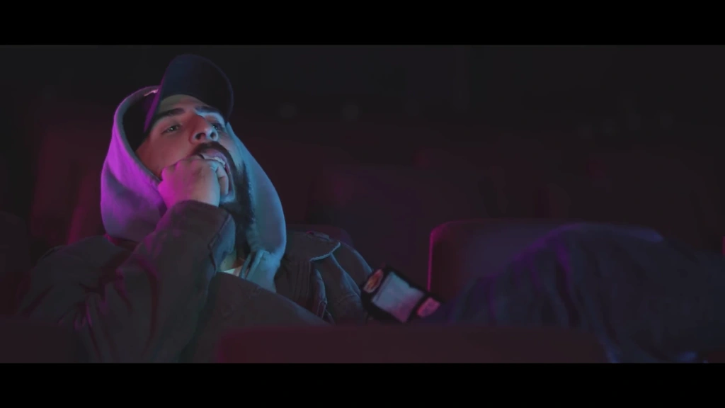 A low camera angle frames llunr against dark surroundings and neon light.