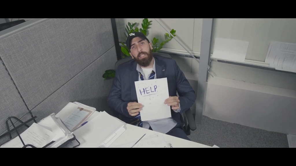 Overhead view of llunr holding a handwritten sign at an office desk.