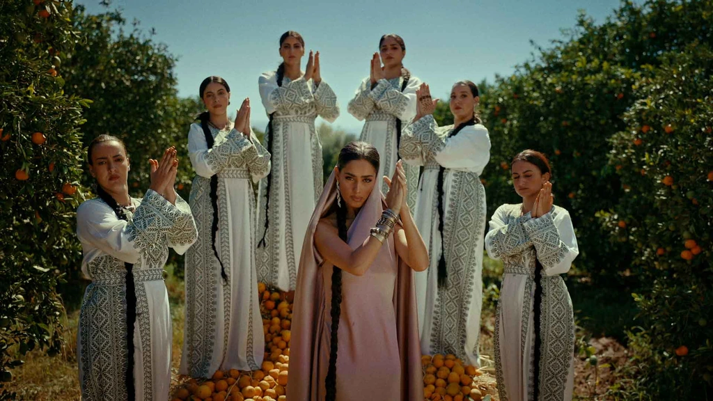 Zeyne and a group of women arranged among orange trees.